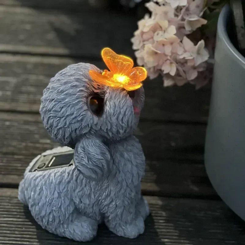 Blue plush toy with a glowing orange butterfly on a wooden surface